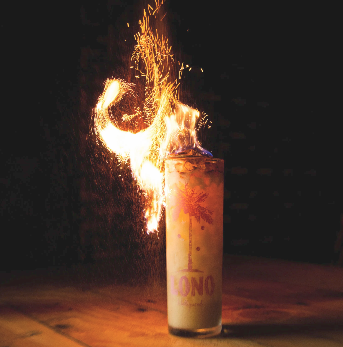 Experiences by Curious with a flaming cocktail